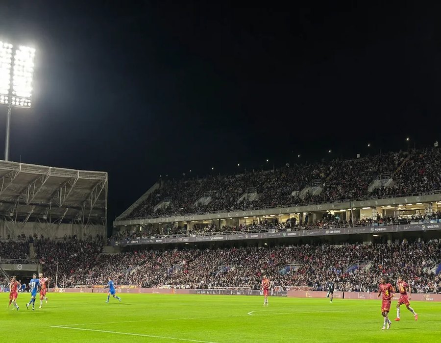 Floodlit football stadium at night